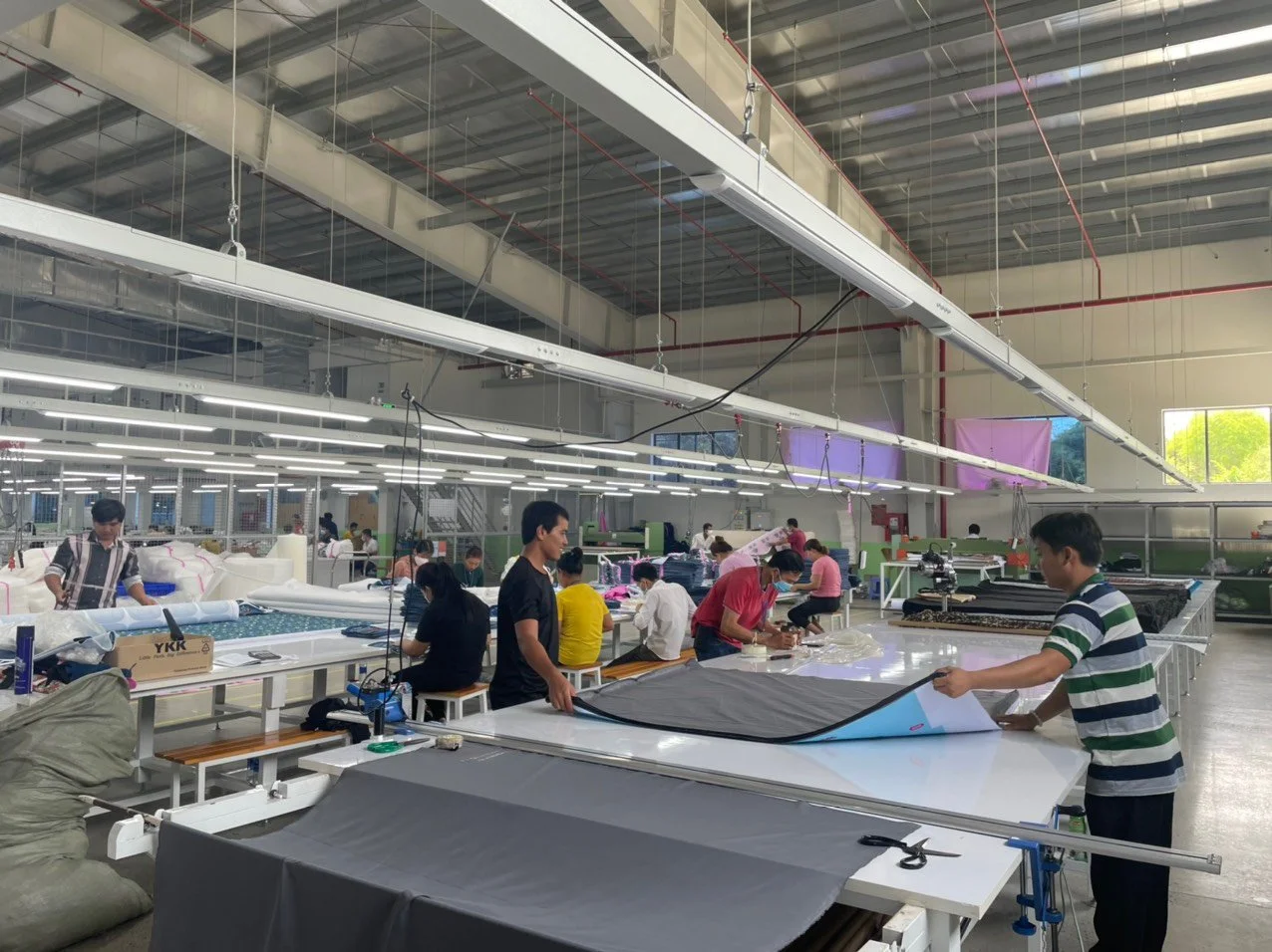 Quality control inspector examining fabric at a Vietnamese textile factory