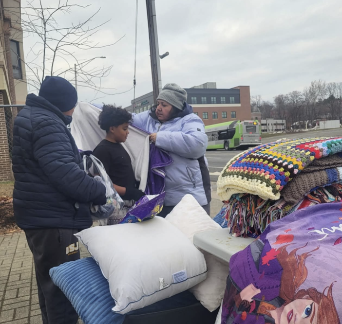 Putting a blanket on a young boy
