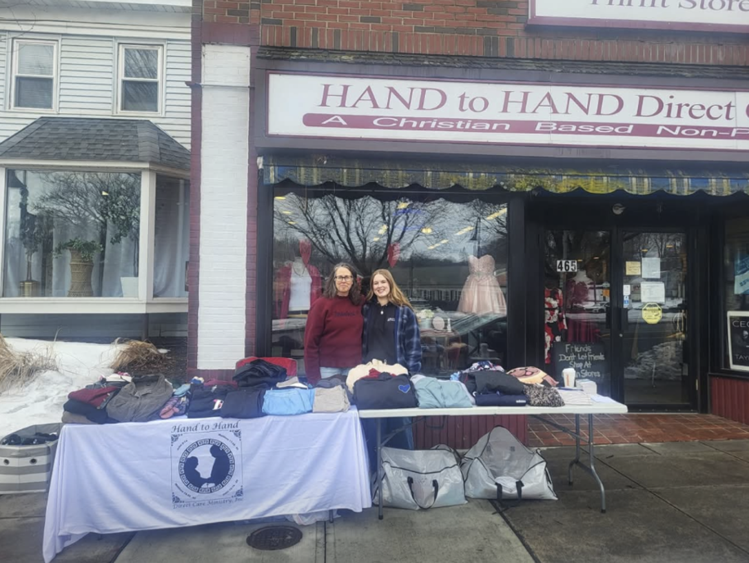 Our volunteer Dawn and her daughter having a clothing giveaway outside of the ministry