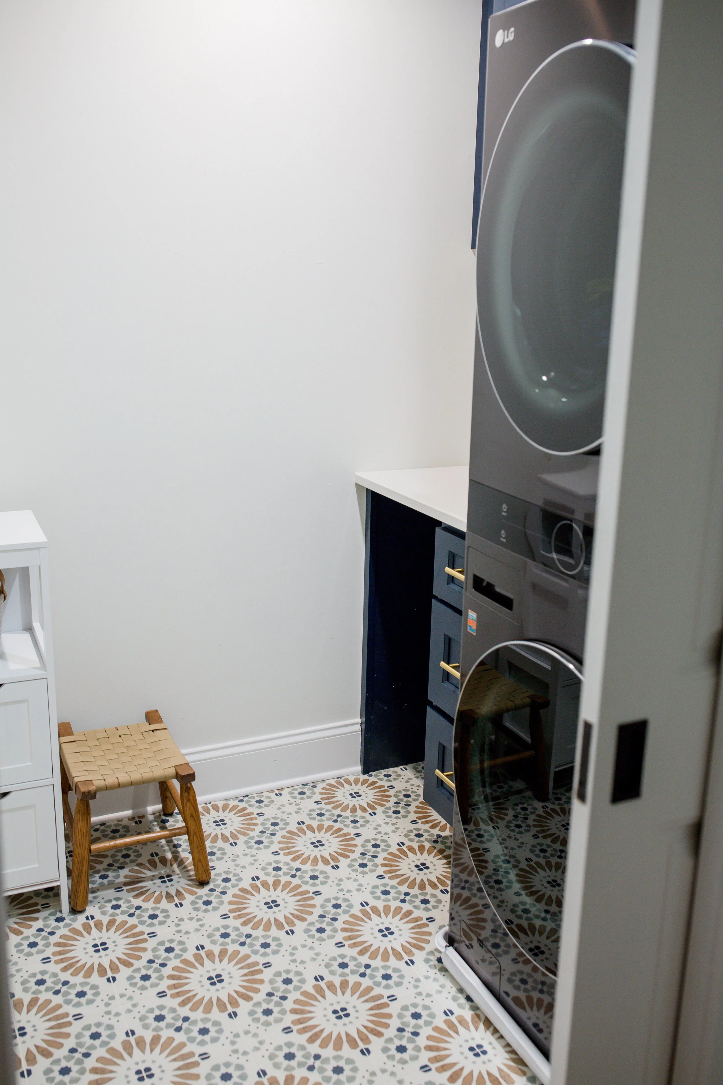 Compact laundry room in Plaza Midwood with stacked washer/dryer, custom desk nook, and fun