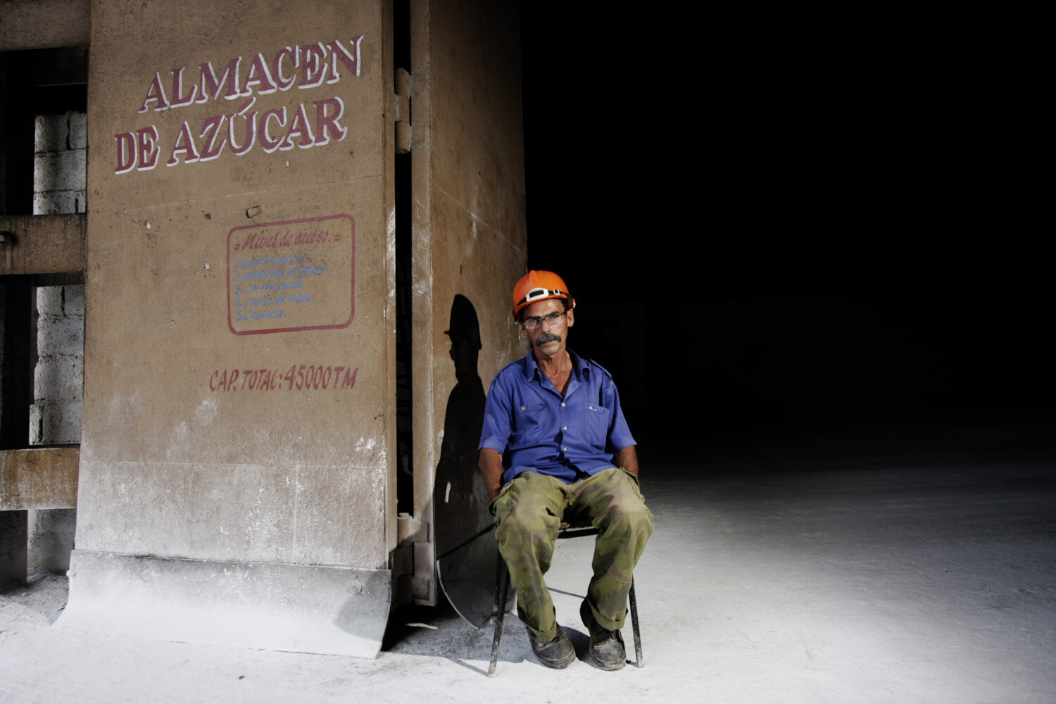  Ortelio,50, poses for a portrait in front of the sugar storehouse of a sugarcane factory, he has been working for 26 years  in the sugarcane industry. 