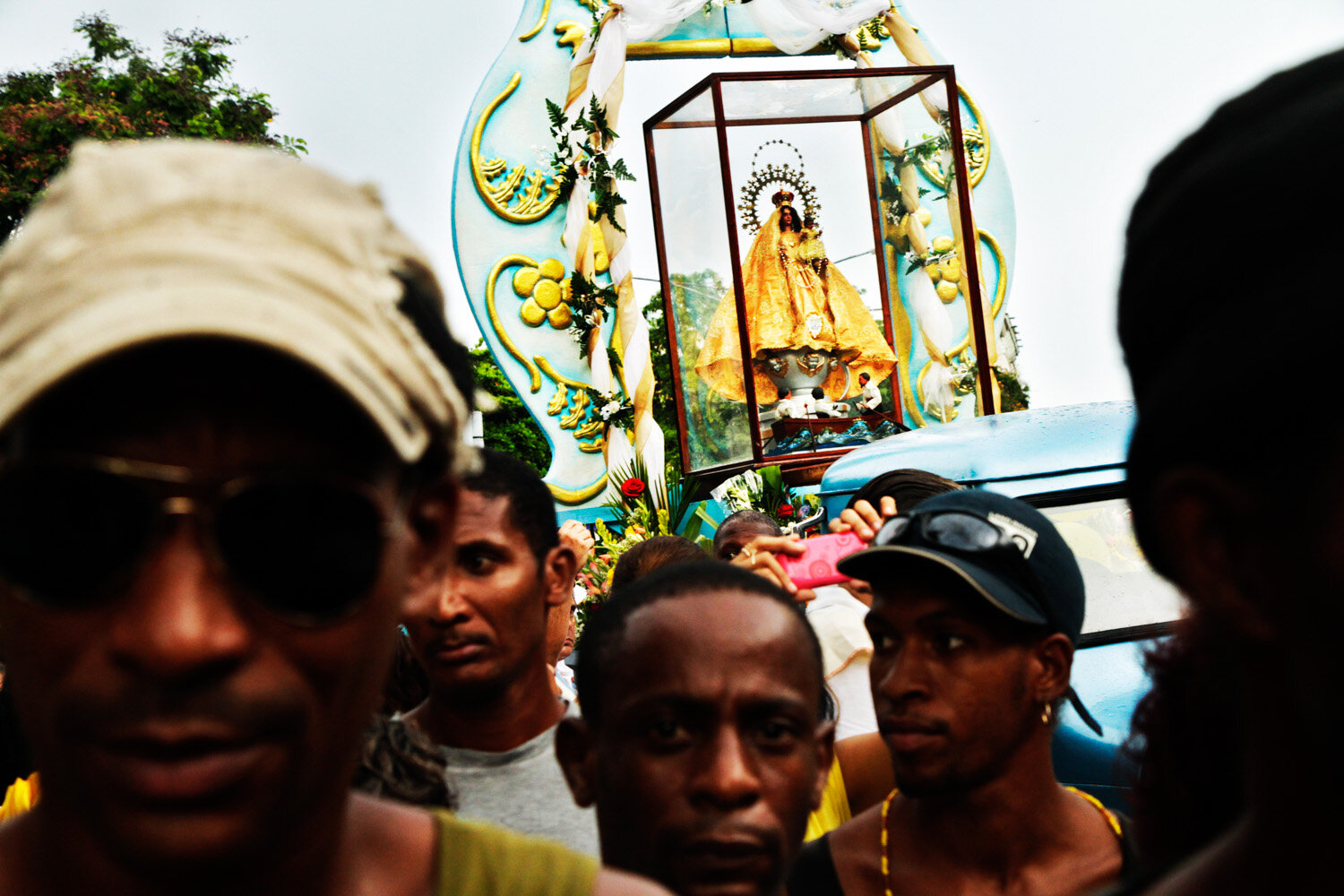  Cubans worship the Virgen de la Caridad de Cobre, Cuba’s national saint, during a procession in Centro Habana, 2010                      