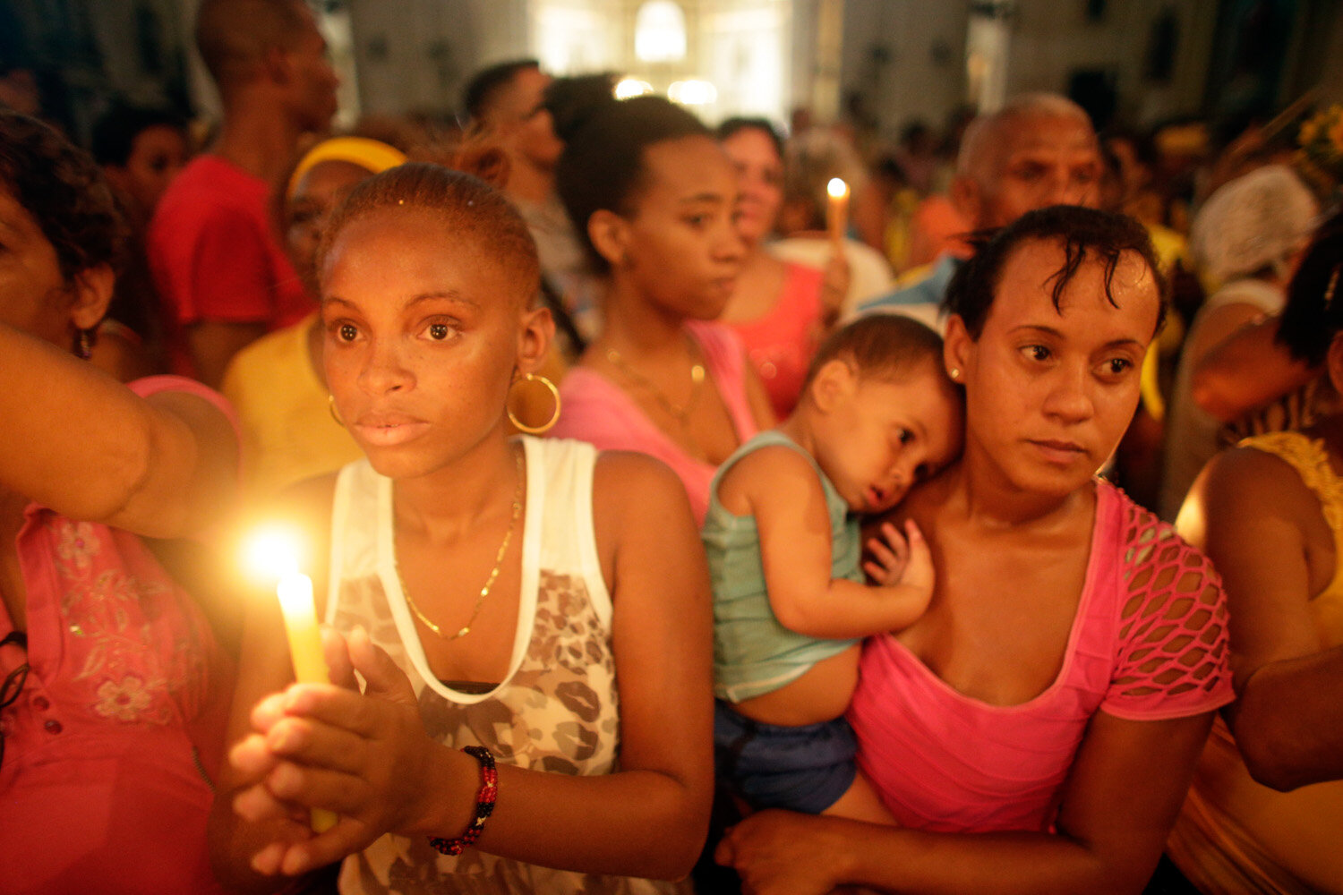  Cubans light candles during a procession for Cuba’s patron saint Virgen de la Caridad de Cobre, 2015                      