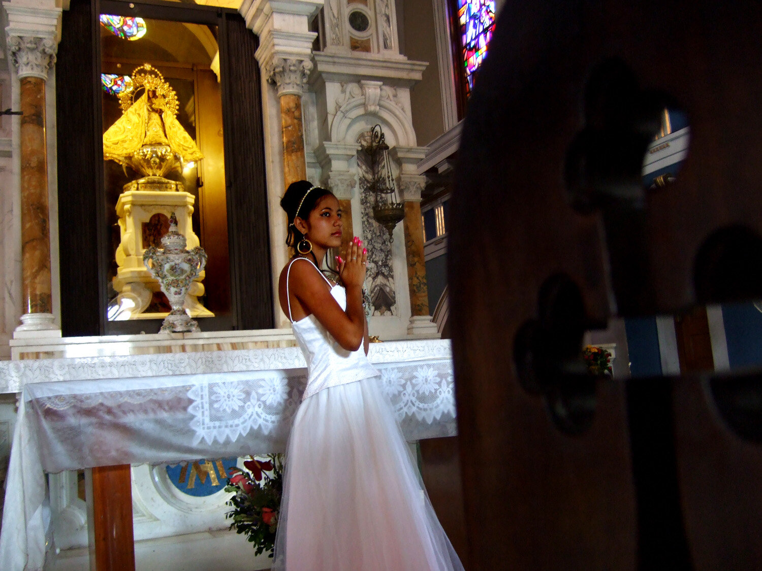  Cuban Quincañera prays to the Caridad de Cobre, 2007                      