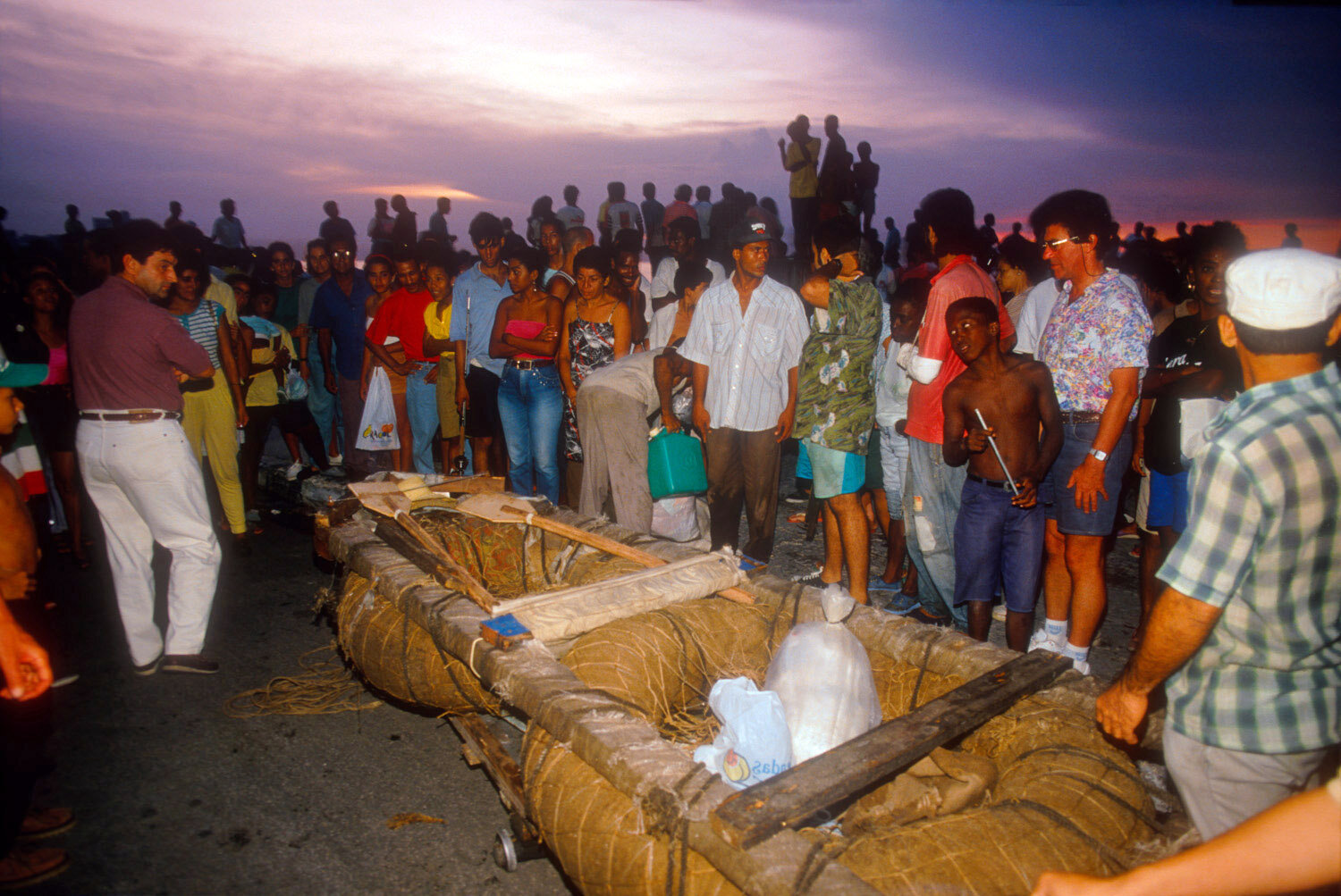  Cubans gather around a balsa, a raft. 