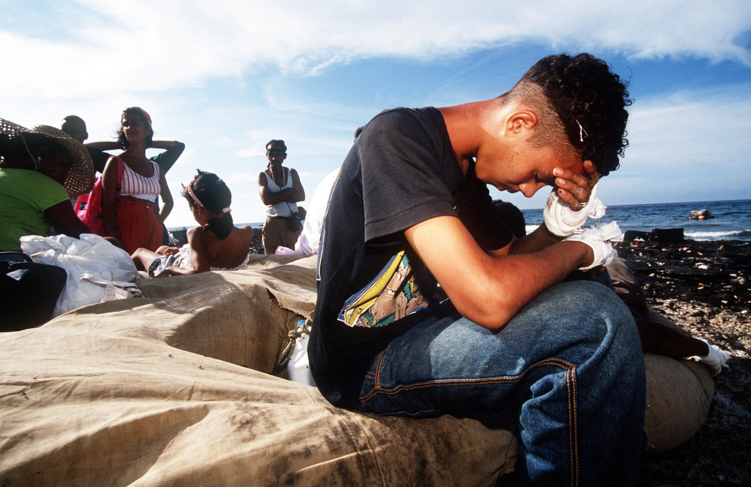  A young Cuban prays prior to his departure on a raft. 