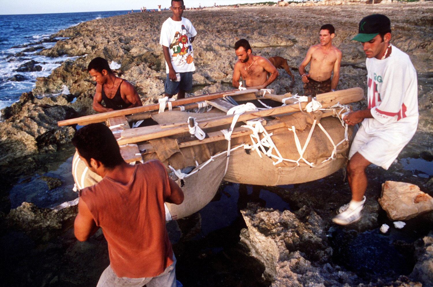  Tony (left, black tanktop) and his friends carry their balsa to the water on the very day that the US and Cuba had finally agreed on an immigration treaty. 