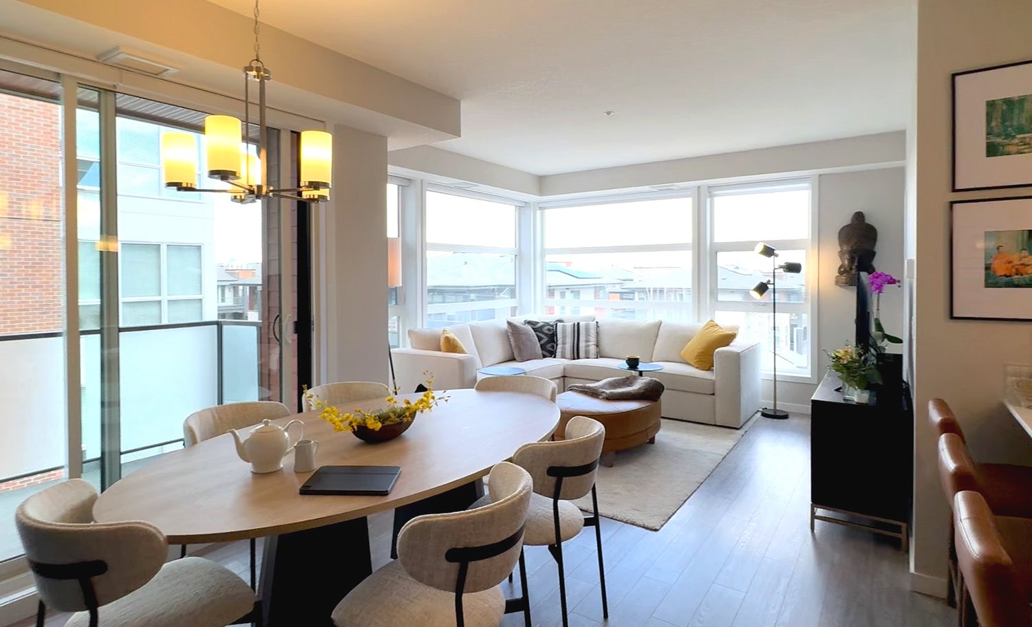 A small condo living room designed with space-saving, proportional furniture in a neutral colour palette to maximize space and create an open, airy feel.