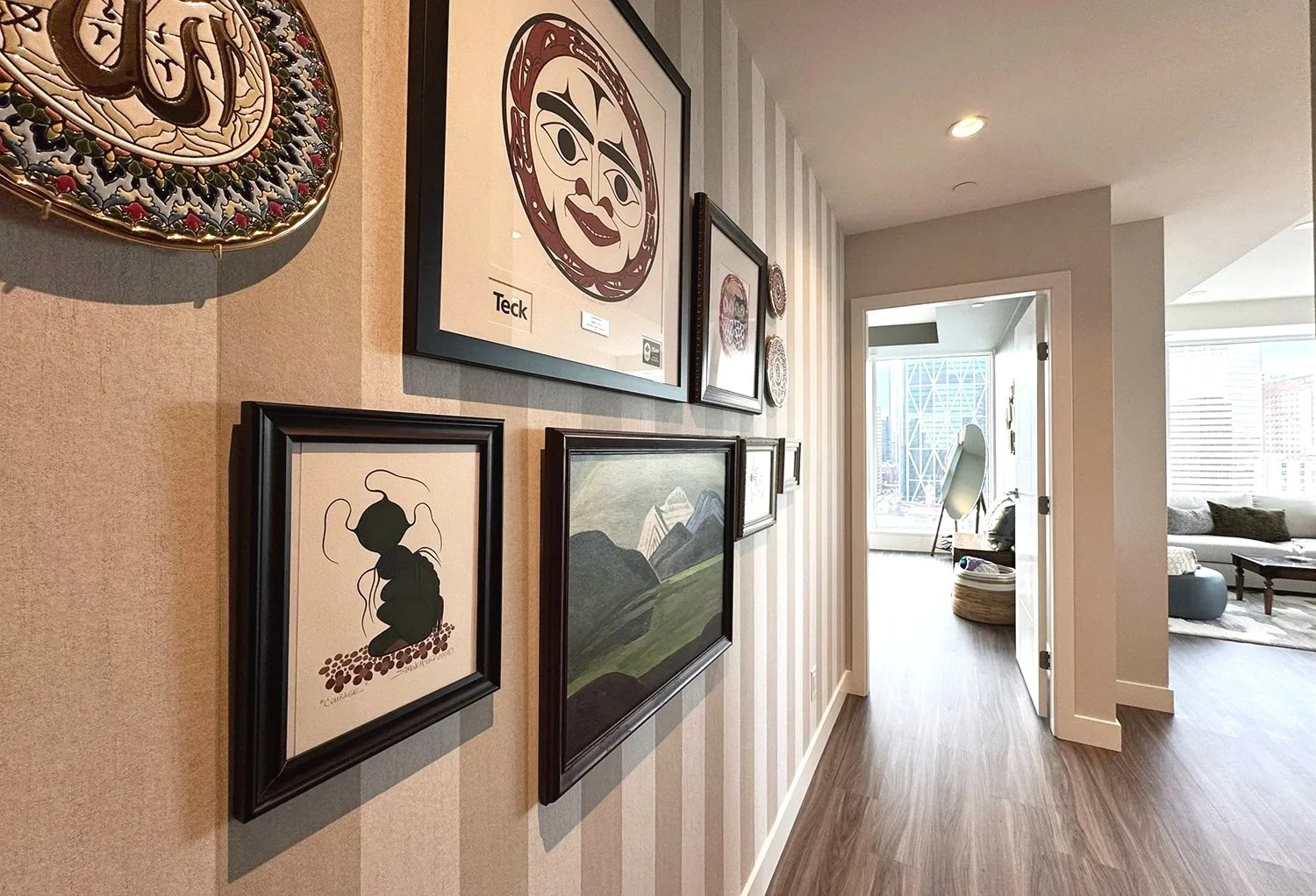 An eclectic condo dining room that blends antique furniture with modern design elements, creating a warm and stylish space set high above the city with stunning views