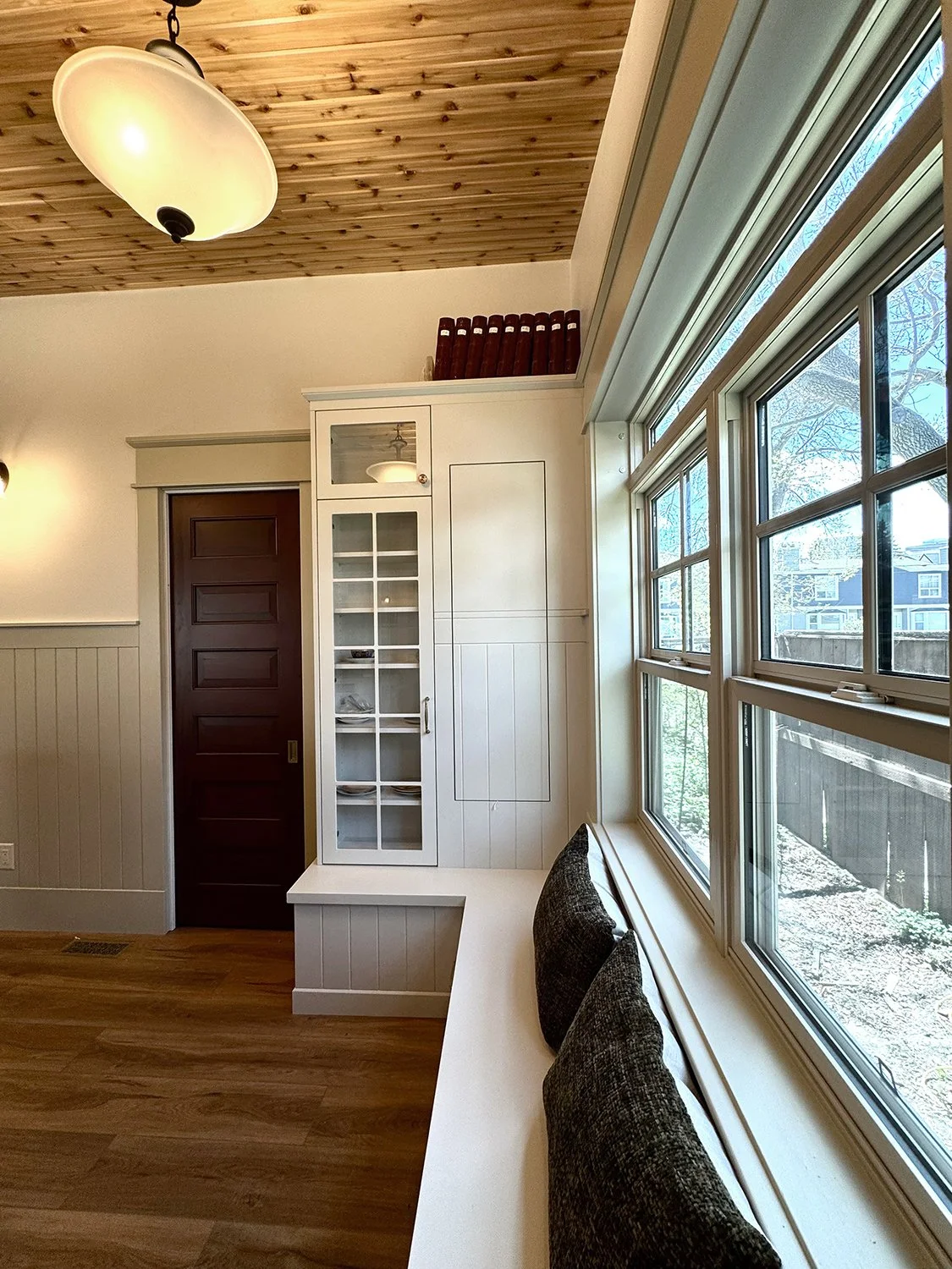 Family room renovation that honours the home’s 1912 Edwardian character while enhancing functionality for modern living. Every detail was thoughtfully considered, from the thicker trim and window casings to traditional wainscoting. 
