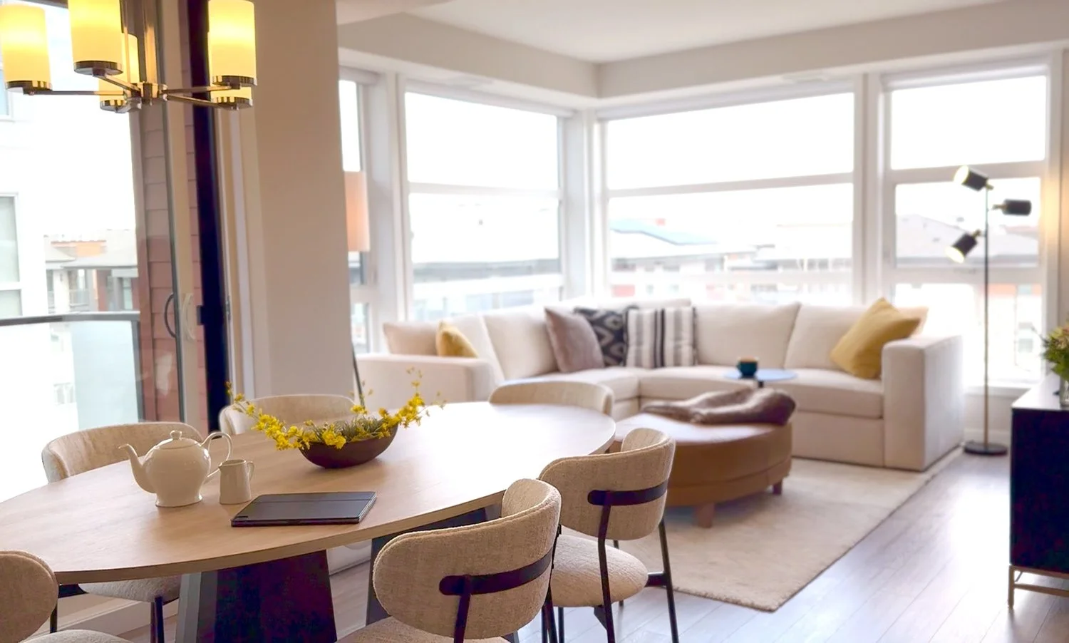 Downsizing from a large home to a small condo. The living room and dining room is designed with space-saving, proportional furniture to maximize space. Using a neutral colour palette to create an open, airy feel.