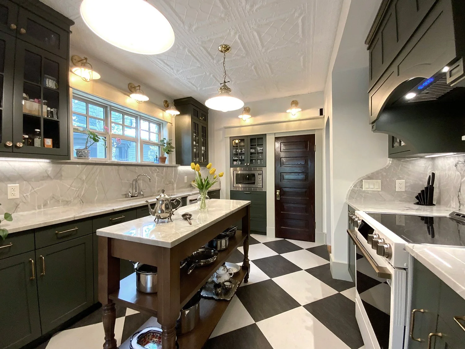 A kitchen renovation that honours the home’s 1912 Edwardian character while enhancing functionality for modern living. Every detail was thoughtfully considered, from the thicker trim and window casings to the Marmoleum checkerboard flooring and decor