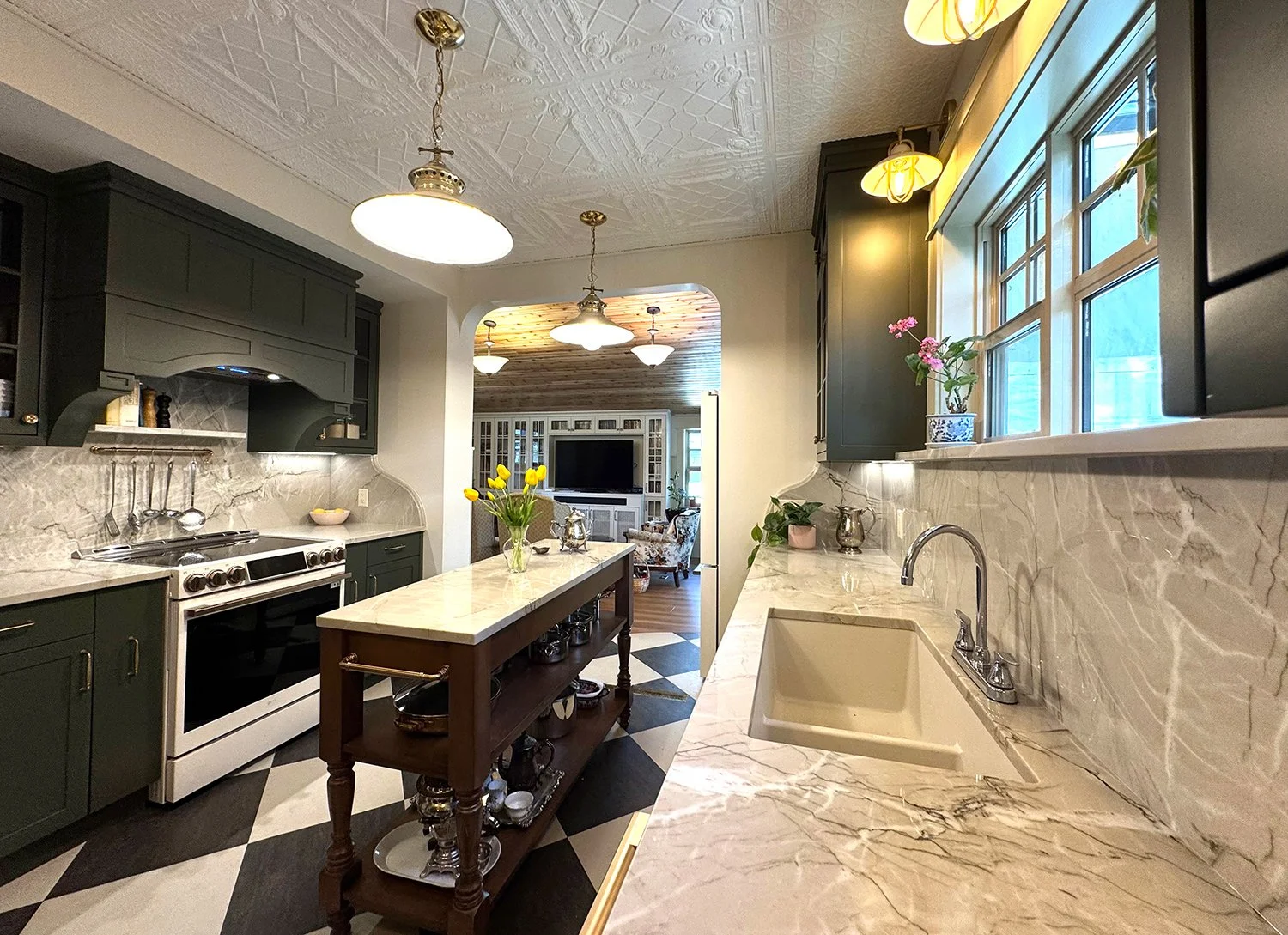 A kitchen renovation that honours the home’s 1912 Edwardian character while enhancing functionality for modern living. Every detail was thoughtfully considered, from the thicker trim and window casings to the Marmoleum checkerboard flooring and decor