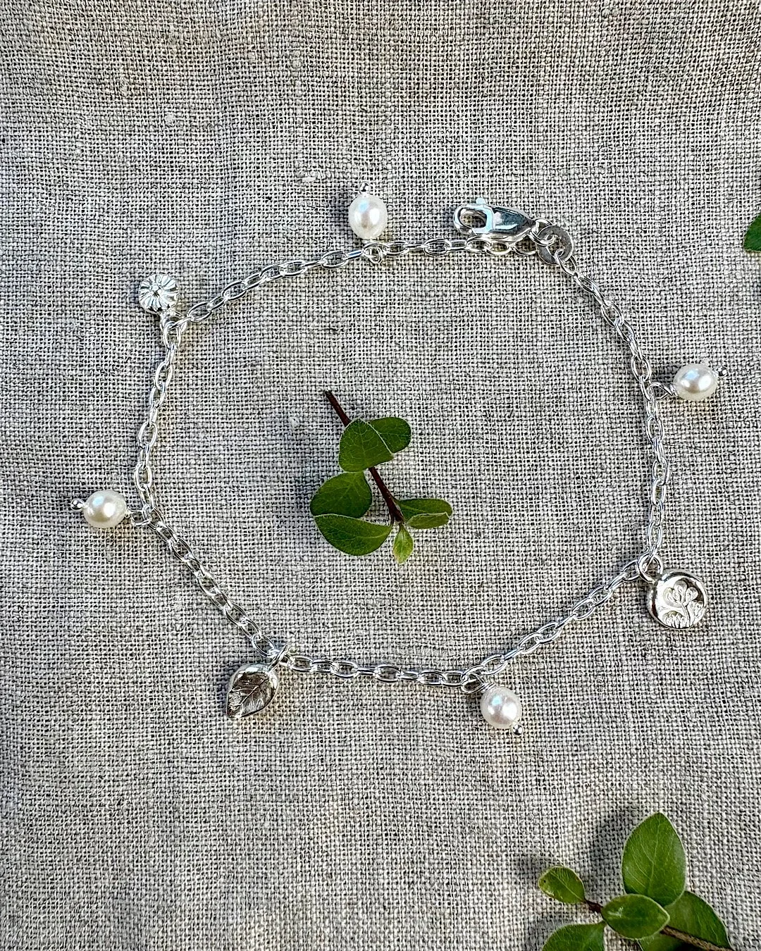 silver-botanical-bracelet-with-leaf-and-flower-charms.jpg