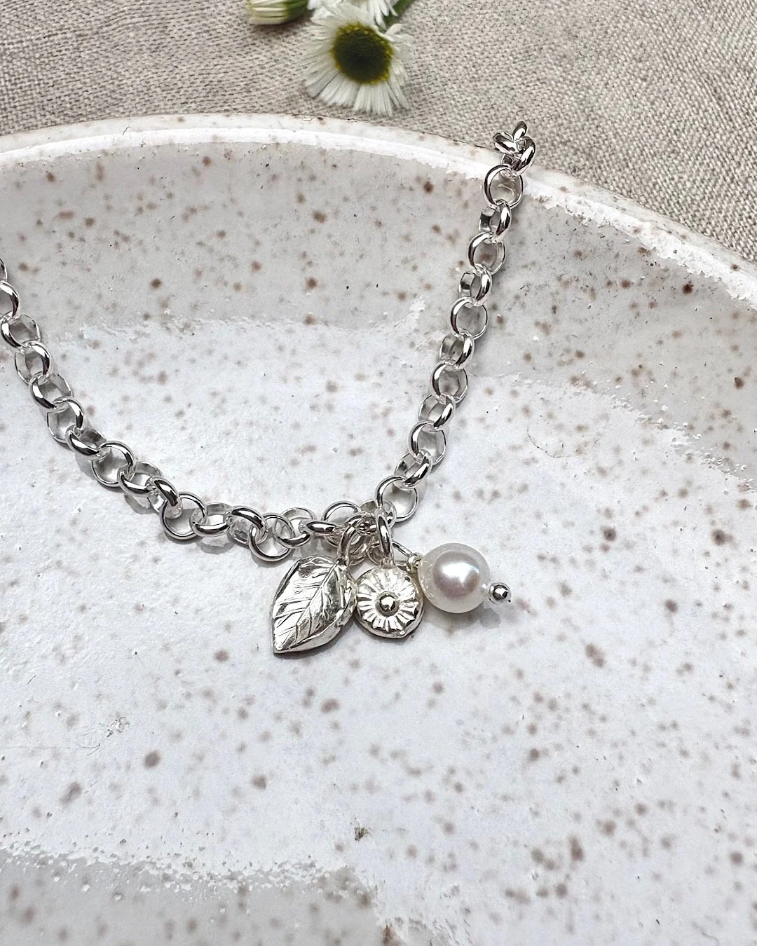 silver-bracelet-with-flower-and-leaf-charms.jpg