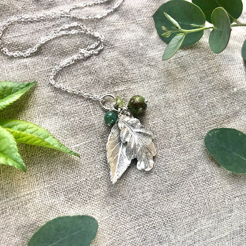 sterling silver leaf necklace with oak and rose leaves on linen background - botanical jewellery
