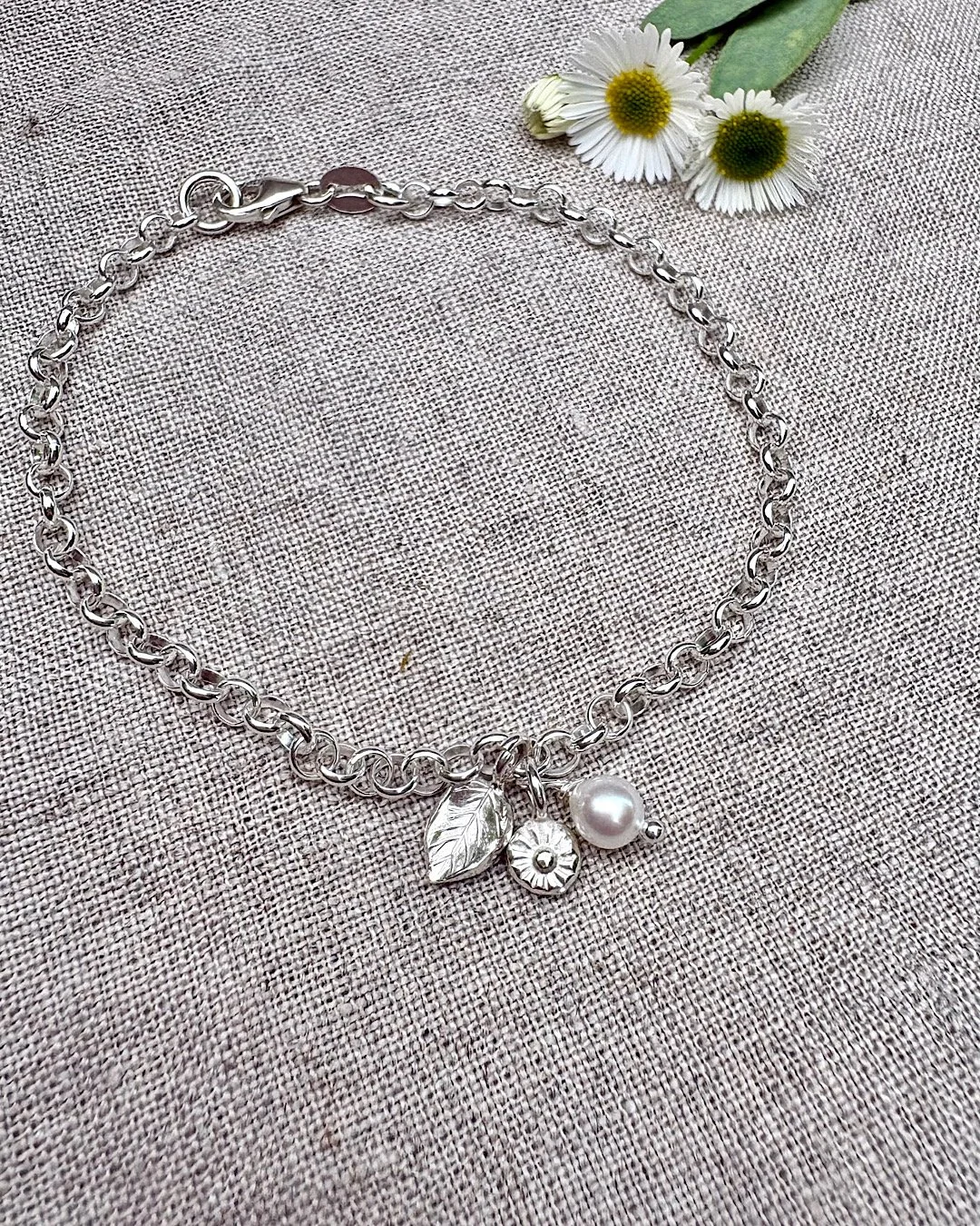 silver-bracelet-with-leaf-and-flower-charms.JPG