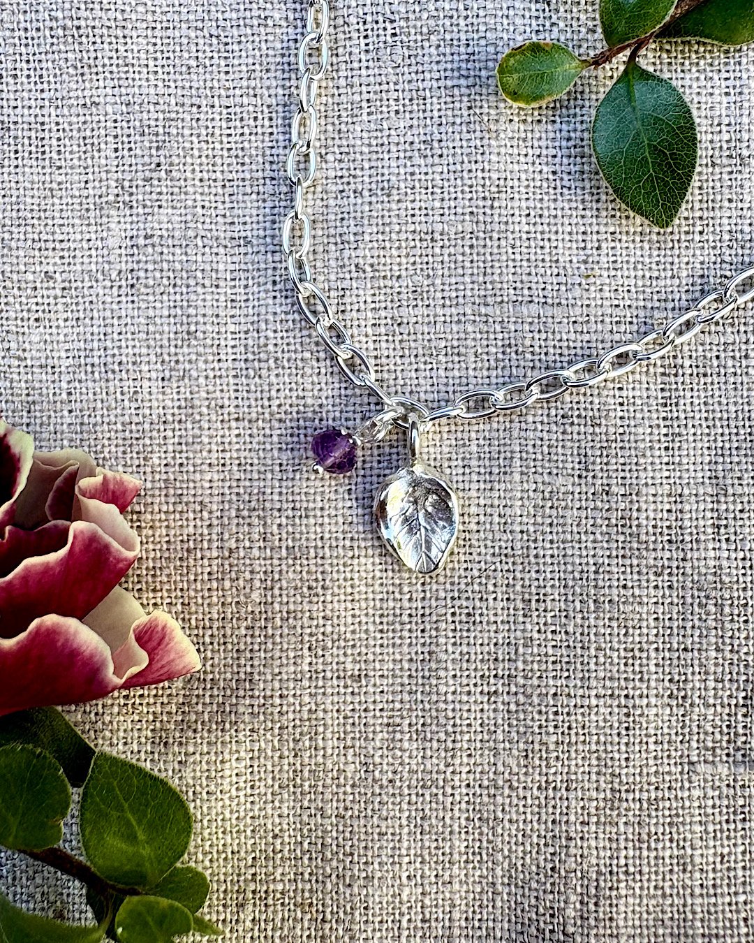 sterling-silver-charm-bracelet-with-leaf-and-gemstone.jpg