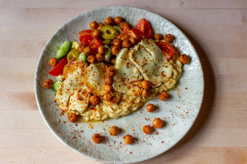 Griddled Halloumi with a cucumber &amp; tomato salad served on a bed of hummus and dressed with dill &amp; Aleppo pepper