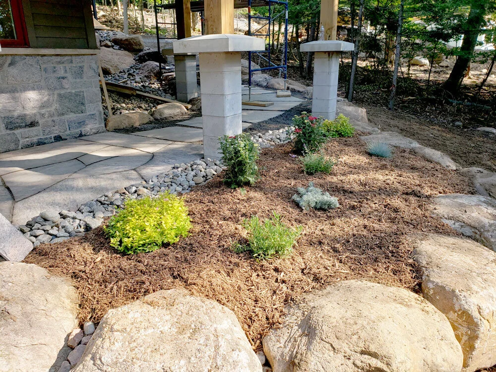 flagstone walkway with rough stone garden beds 