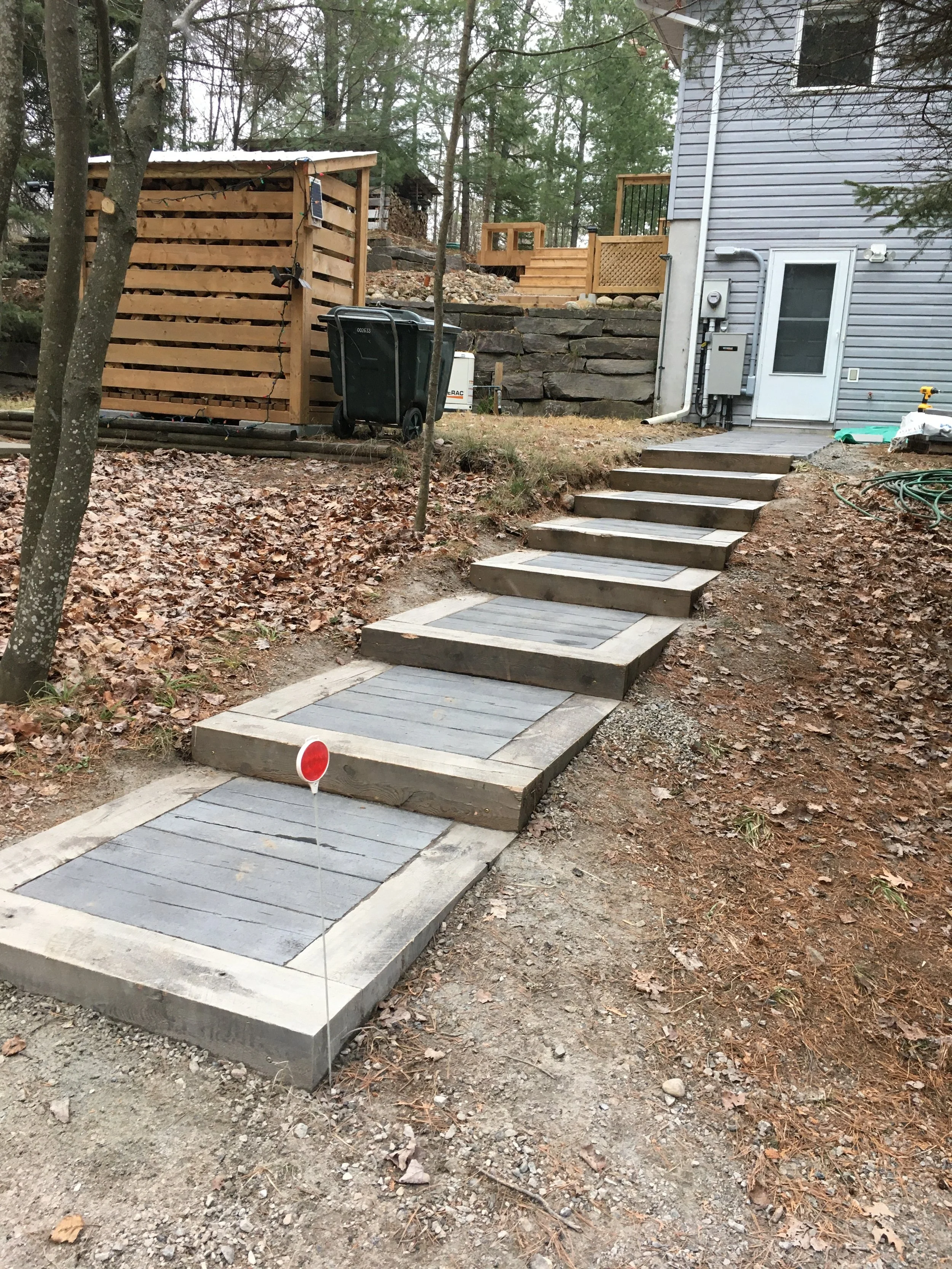 installation of a textured concrete slab sidewalk from Brooklin Barnboard Patio Slabs
