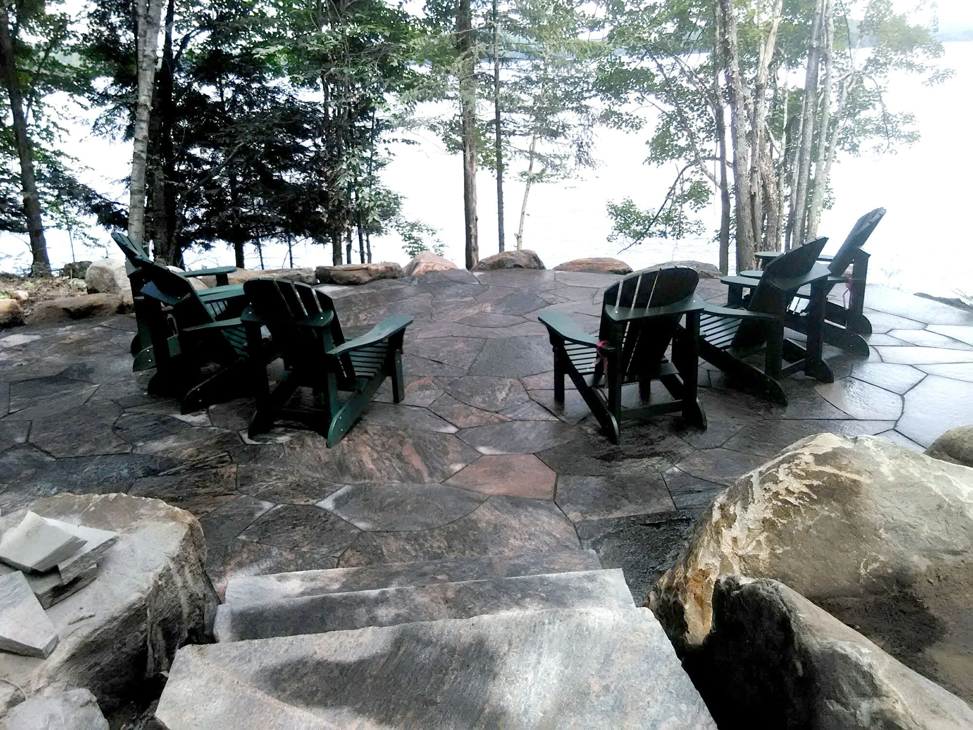 Flagstone Muskoka patio with Muskoka chairs overlooking the lake. 