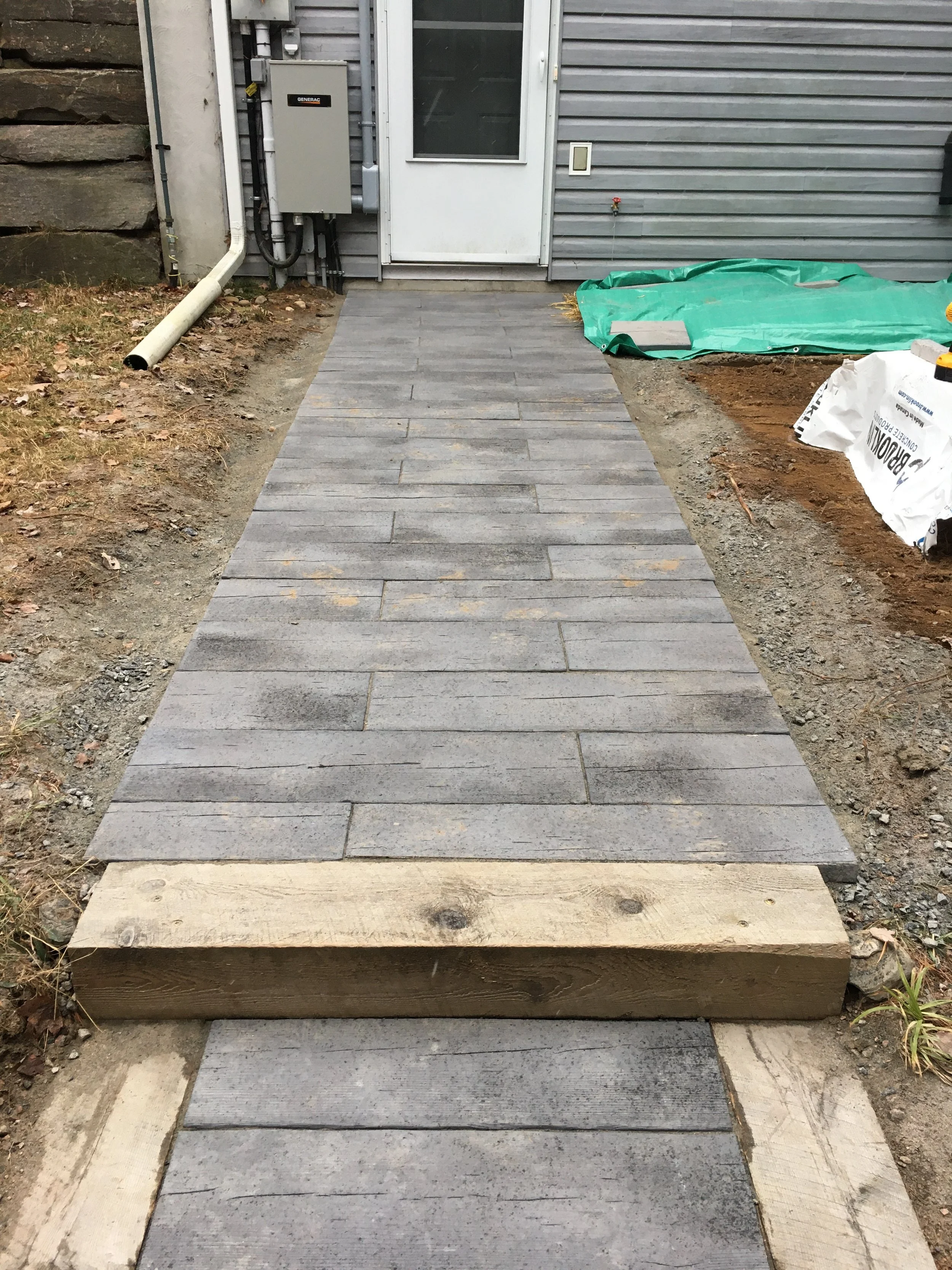 installation of a textured concrete slab sidewalk from Brooklin Barnboard Patio Slabs