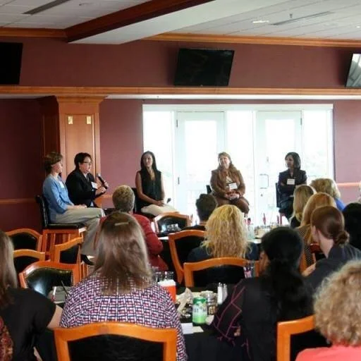 women sitting around a group talking