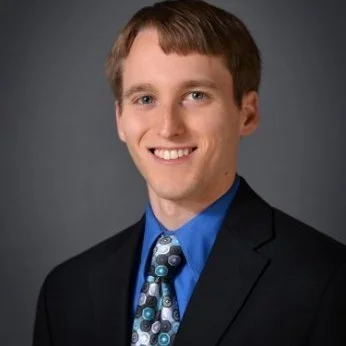 Man in a suite smiling at the camera