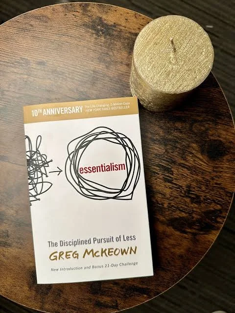 Image of a book on a table next to a candle