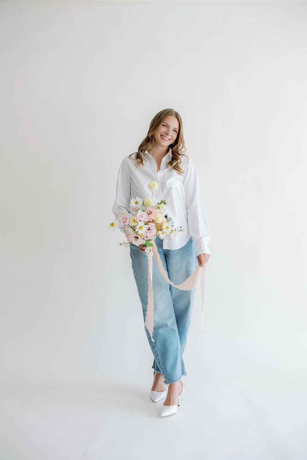 Minne Floral Co.'s Owner and designer - Hannah Ampe featuring a season summer bridal bouquet with zinnia, dahlias, and cosmos.