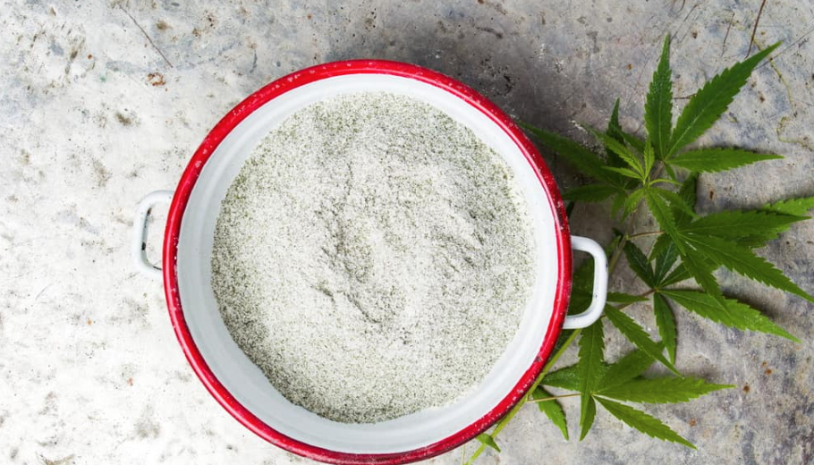 Image of Hemp CBD Isolate powder in a pot with cannabis leaves next to it