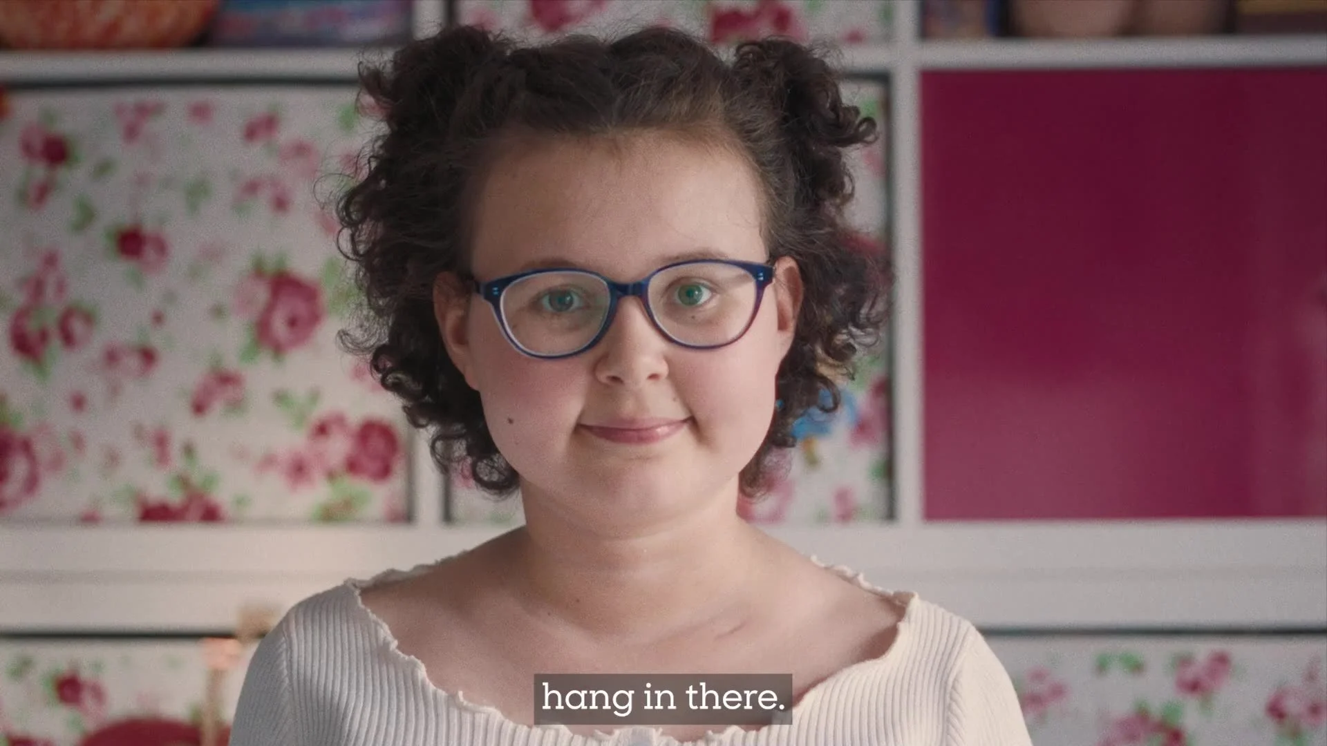 A portrait of Alyssa from Rocking Horse Pictures’ inspiring Blood Cancer UK campaign video, with a hopeful expression and a floral background, conveying a message of resilience and optimism for those affected by blood cancer.