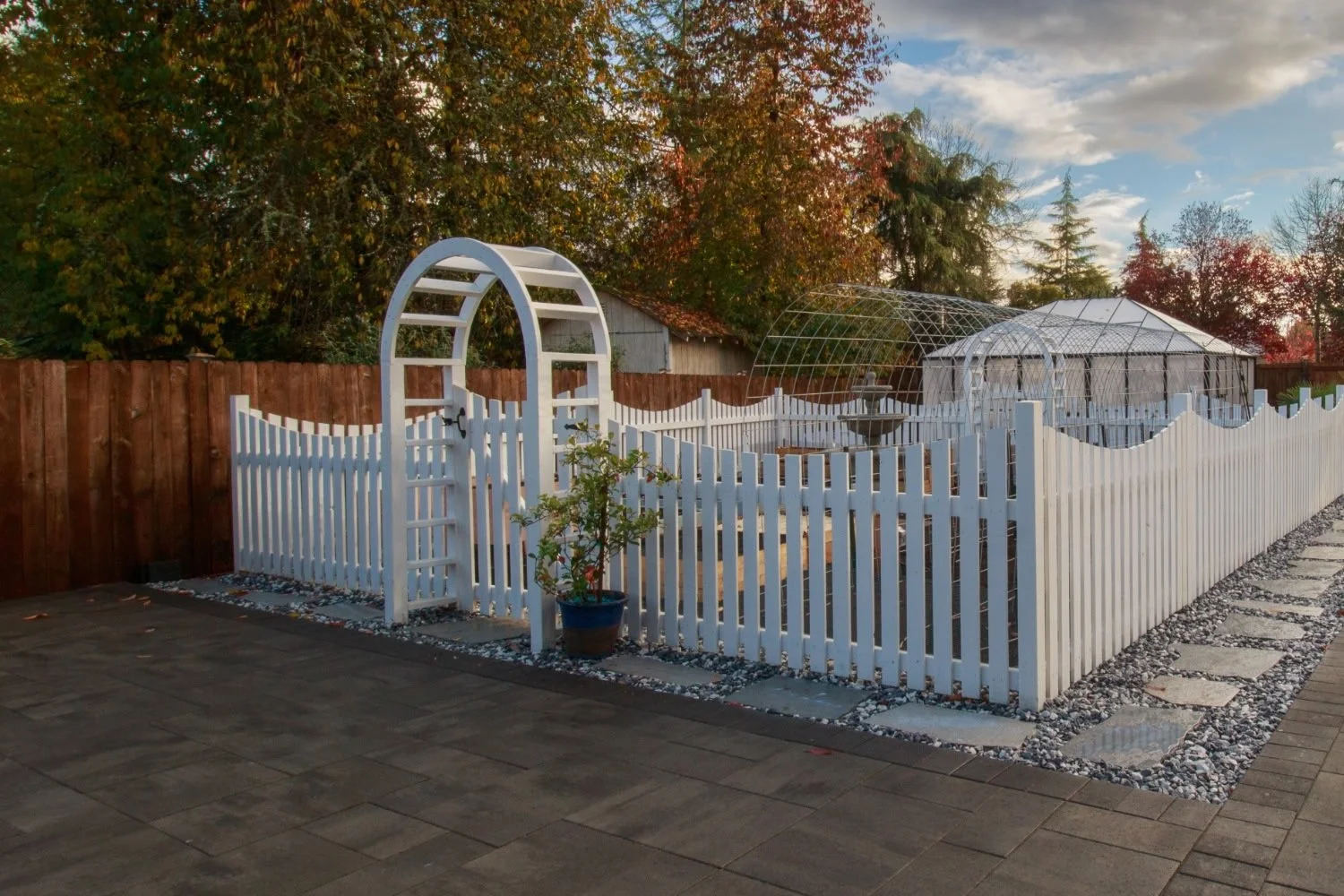 Paver patio with picket fence and gravel garden path in Lacey, WA