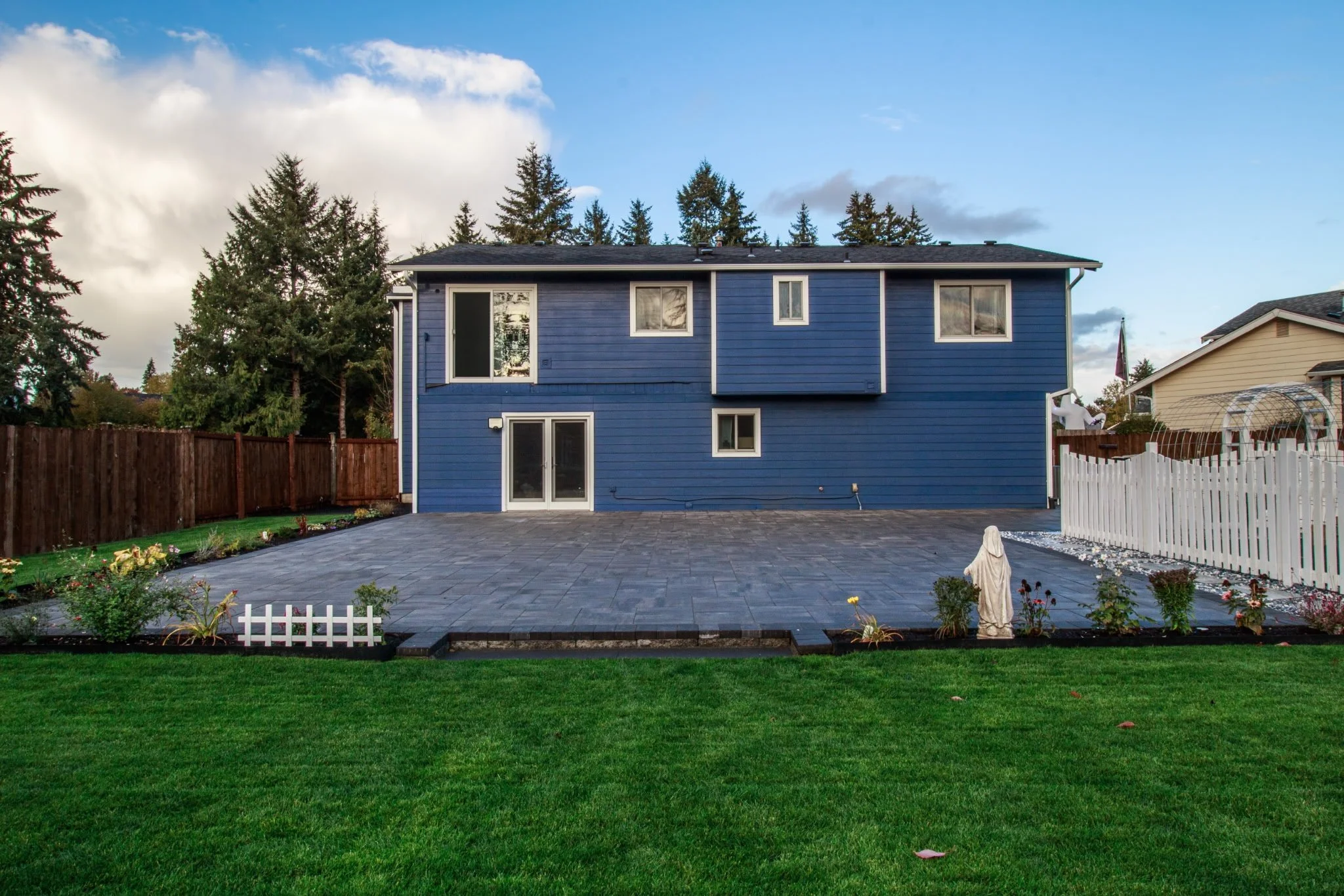 New paver patio, sod lawn and picket fence installed by Lawn Boys Landscape in Lacey, WA