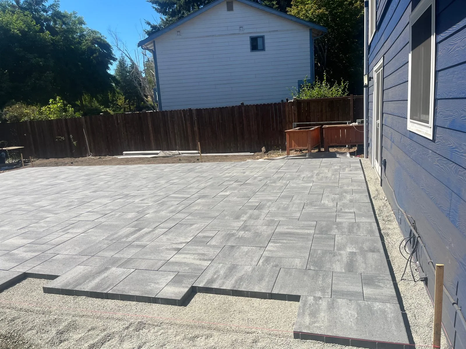 Gray paver patio running along the side of a house in Lacey, WA