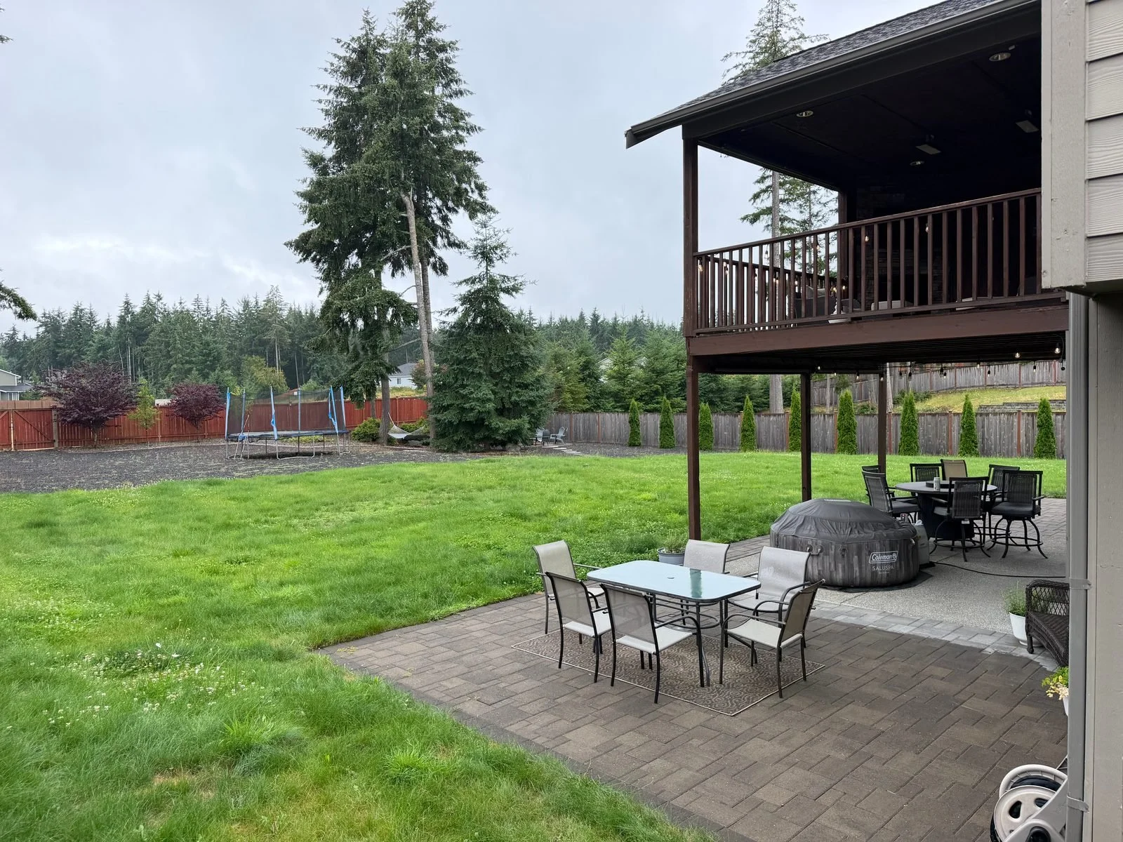 Paver patio with patio furniture in an Olympia, WA backyard