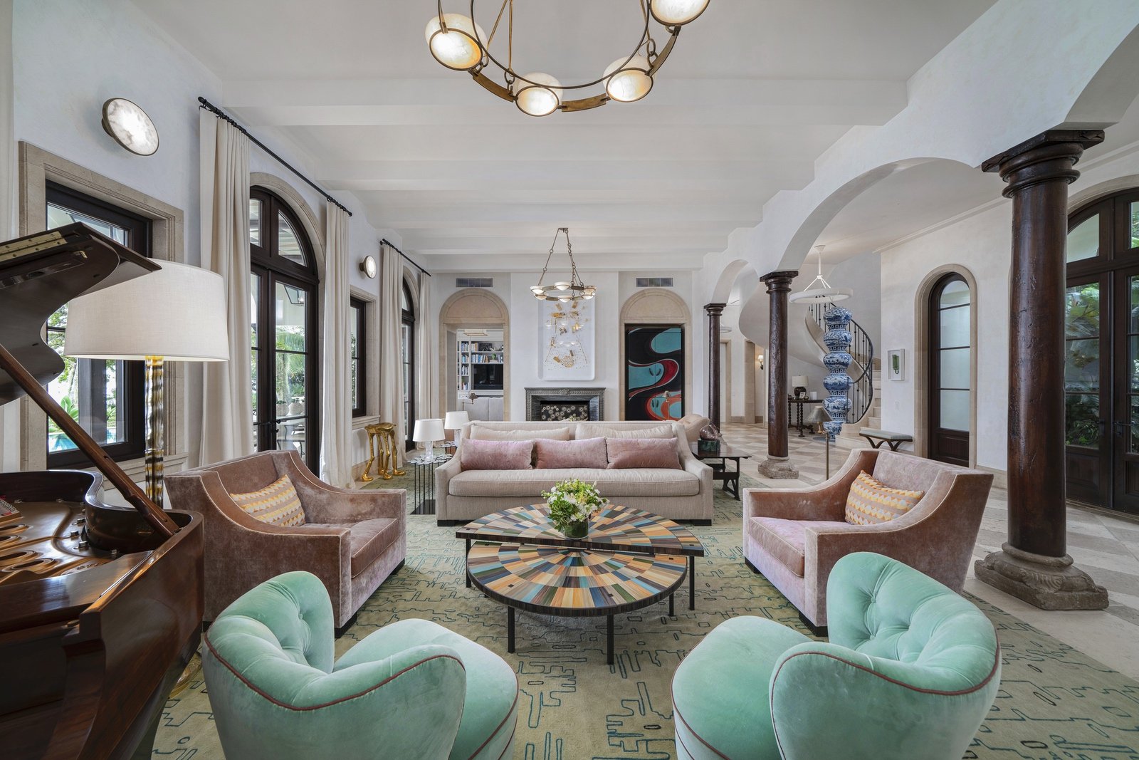 Elegant living room with a grand piano, pastel sofas, and modern decor.
