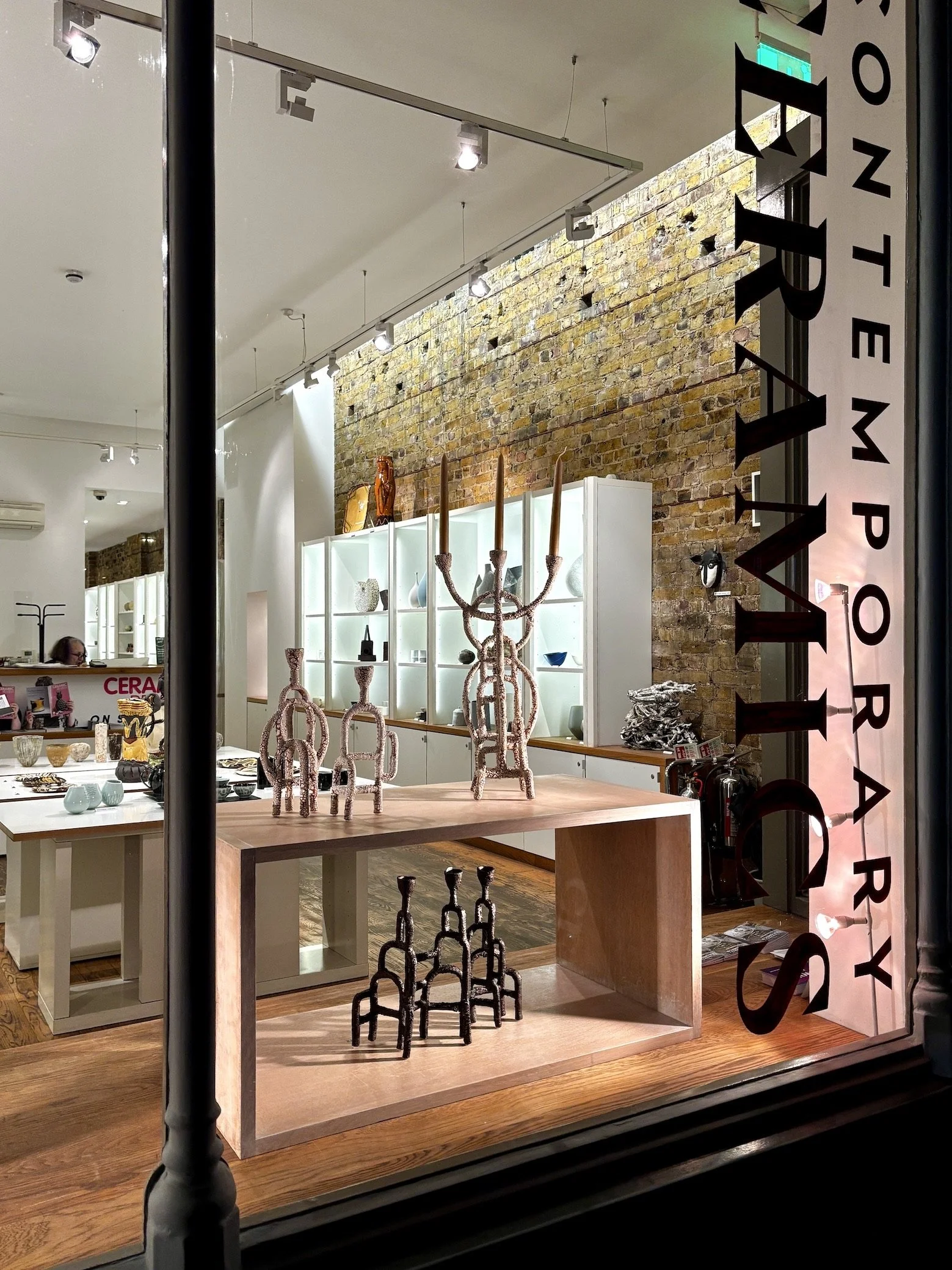 window of craft potters gallery with candlesticks by gunn ceramics