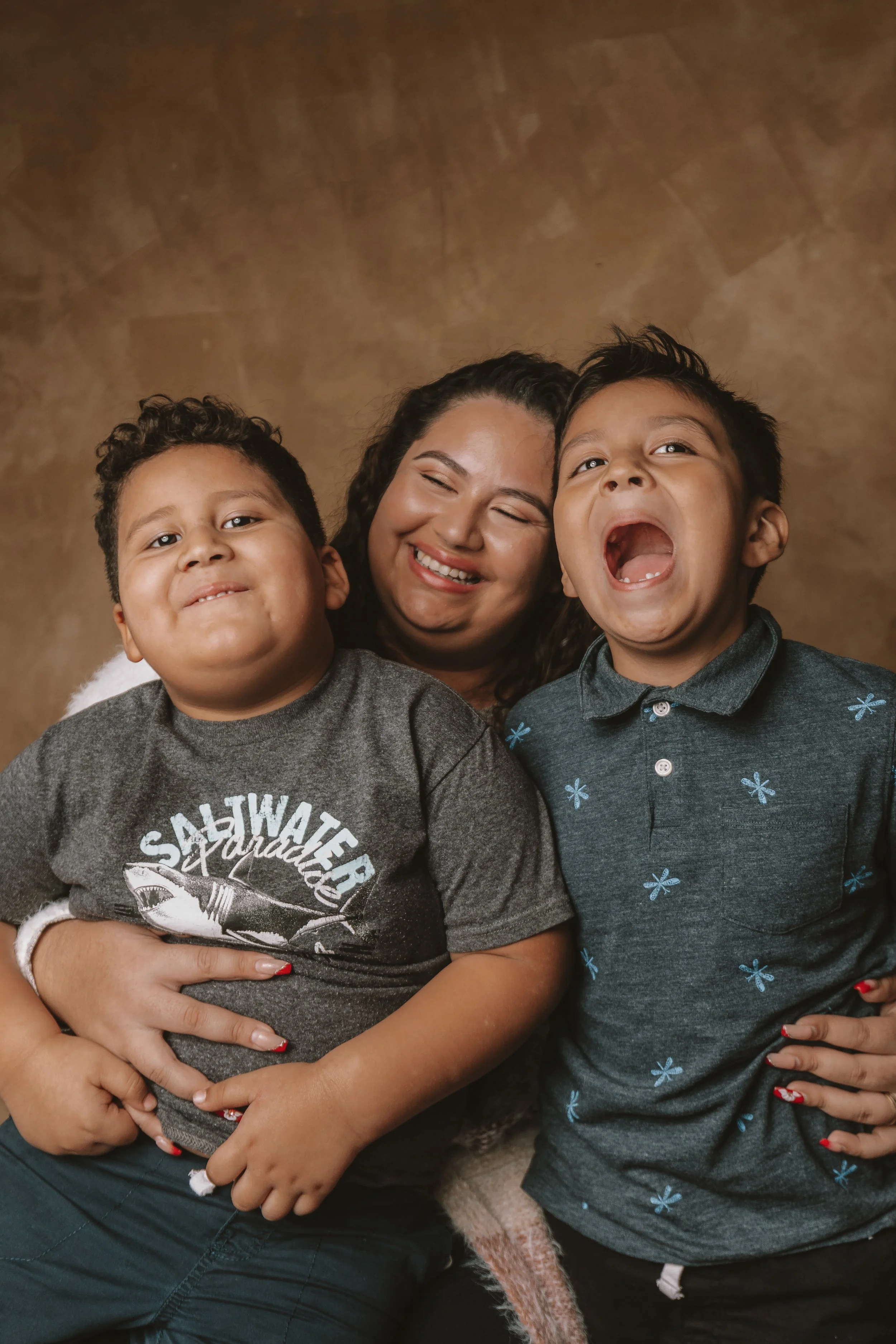 University of Maryland Alumna Yoslin Amaya smiling with her two children.