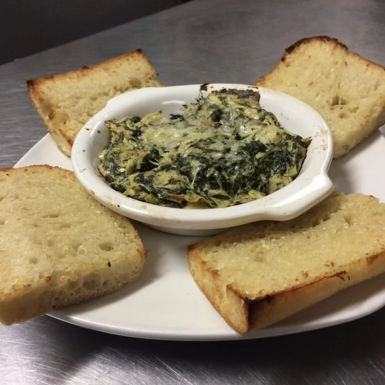 Cheesy, creamy, dipping goodness, with the perfect blend of garlic and spice.&nbsp; This stuff is sure to please!&nbsp; Served with a side of sliced, toasted Italian baguette.$9.35