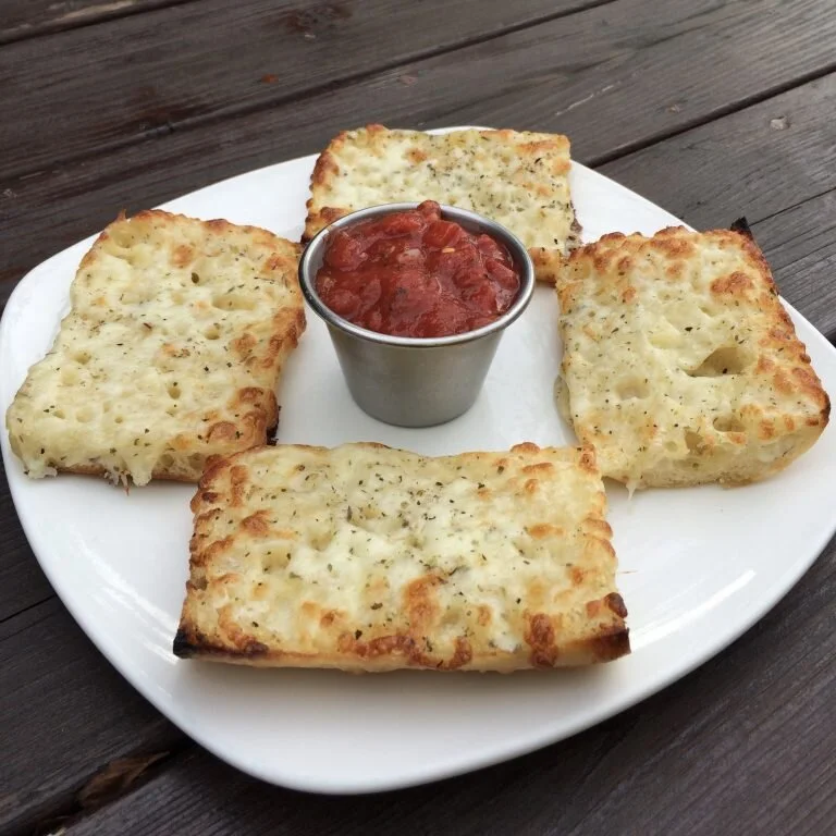 Locally crafted Italian baguette loaded with mozzarella cheese and garlic butter.&nbsp; We finish it off with a touch of herbs and spices.&nbsp; Served with a side of red sauce.Regular:  $6.00Vegan:  $6.30