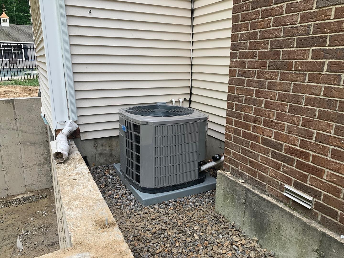 Dropping a condenser back into place after foundation is poured and back filled. #hvaccontractor
