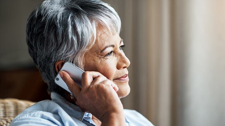 Senior citizen smiling on the phone