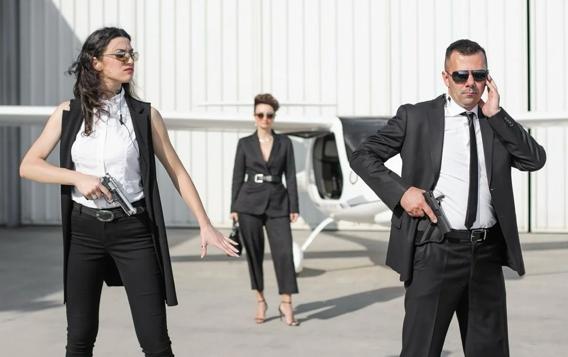 Tacticool at its finest.

Two Executive Protection agents, flexing with guns out&mdash; looking more ready for a movie trailer than an actual movement.

Because nothing says &ldquo;discreet&rdquo; like putting the Principal on full display&mdash;cent