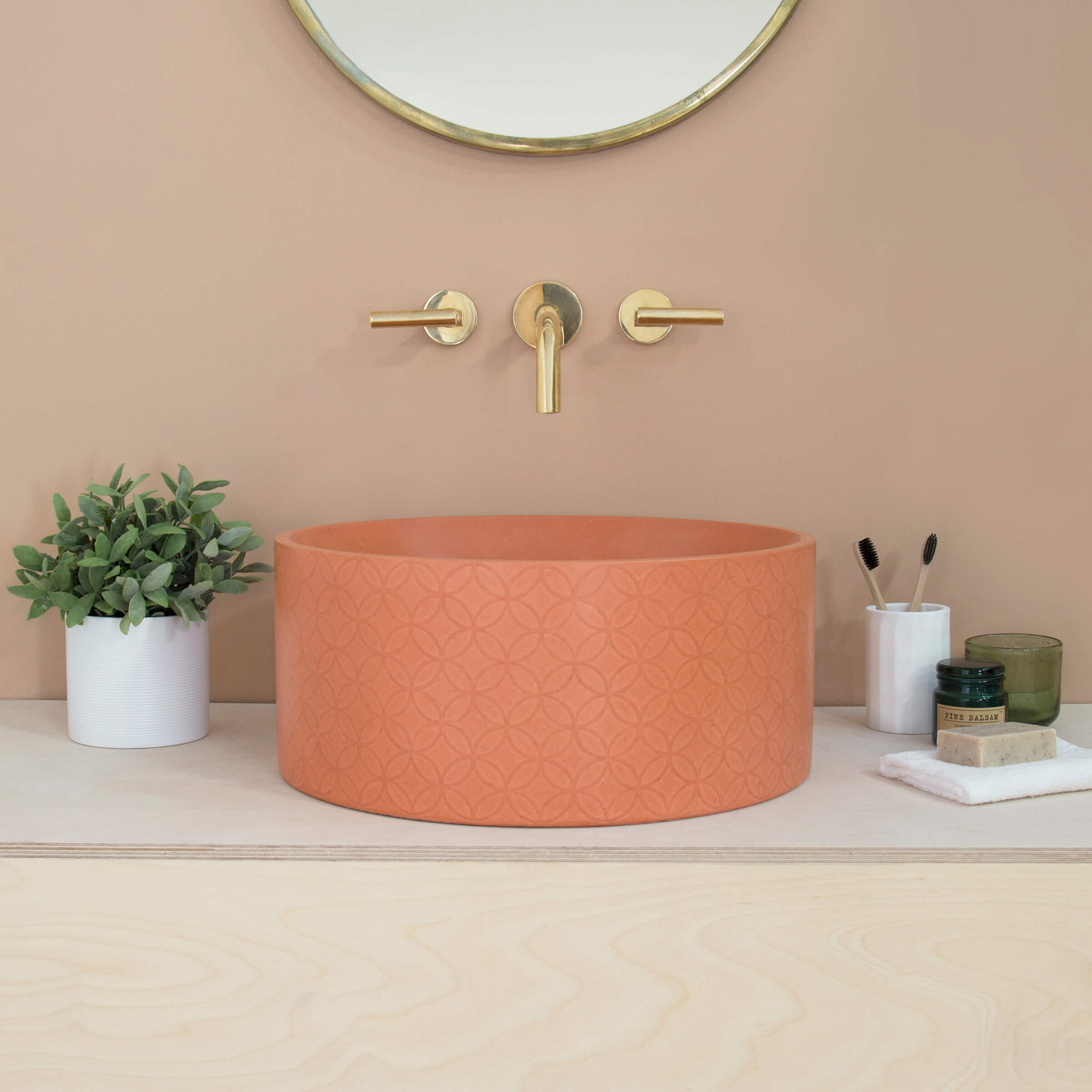 Orange, surface-mounted countertop concrete vessel basin sink with a bowl interior and decorative geometric surface pattern. (Copy)