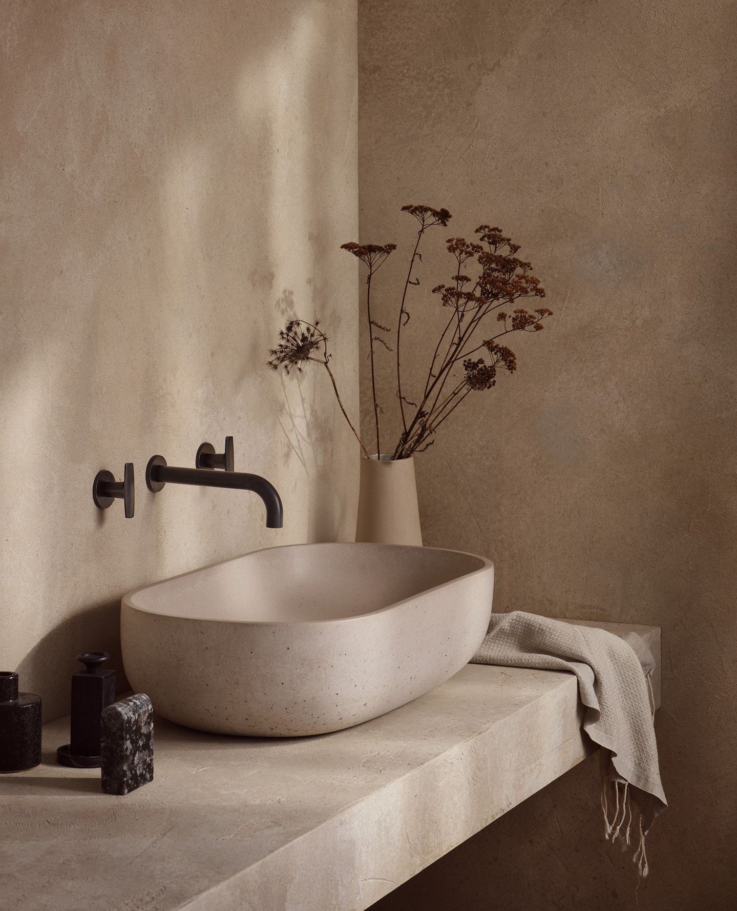 Soft, neutral tones and dappled lighting meet rich texture in this stunning bathroom for @samuelheathofficial featuring our Rho basin.⁠
⁠
📷️ by @sibev⁠
Image @samuelheathofficial⁠
Styling @emilyrickardstyle⁠
⁠
⁠
#concretebasin #concretesink #washbas