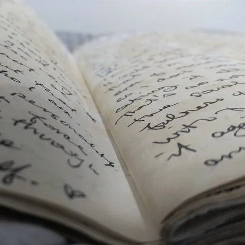 close up image of a journal opened to a page with handwriting