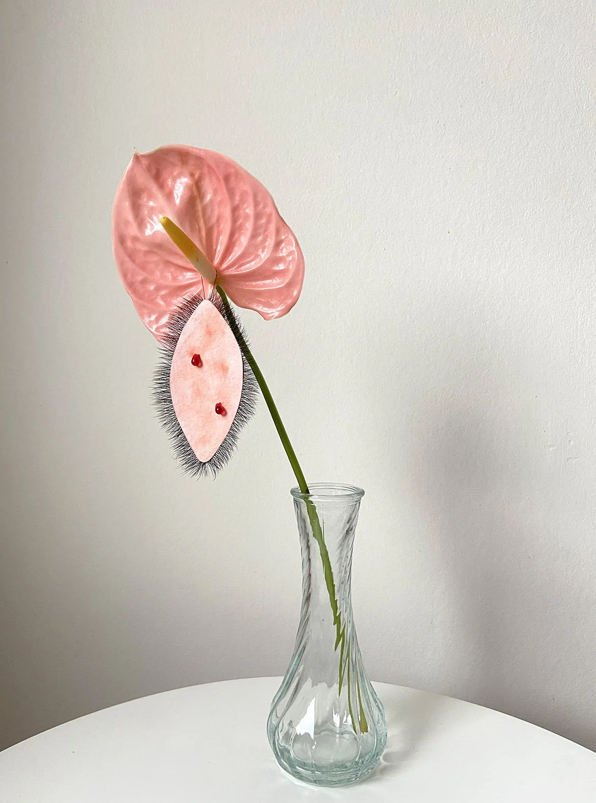 Lashing Around, 2025. Watercolour drawing, anthurium flower, vase, fake lashes, glass drops. 5cm x 7cm approx.