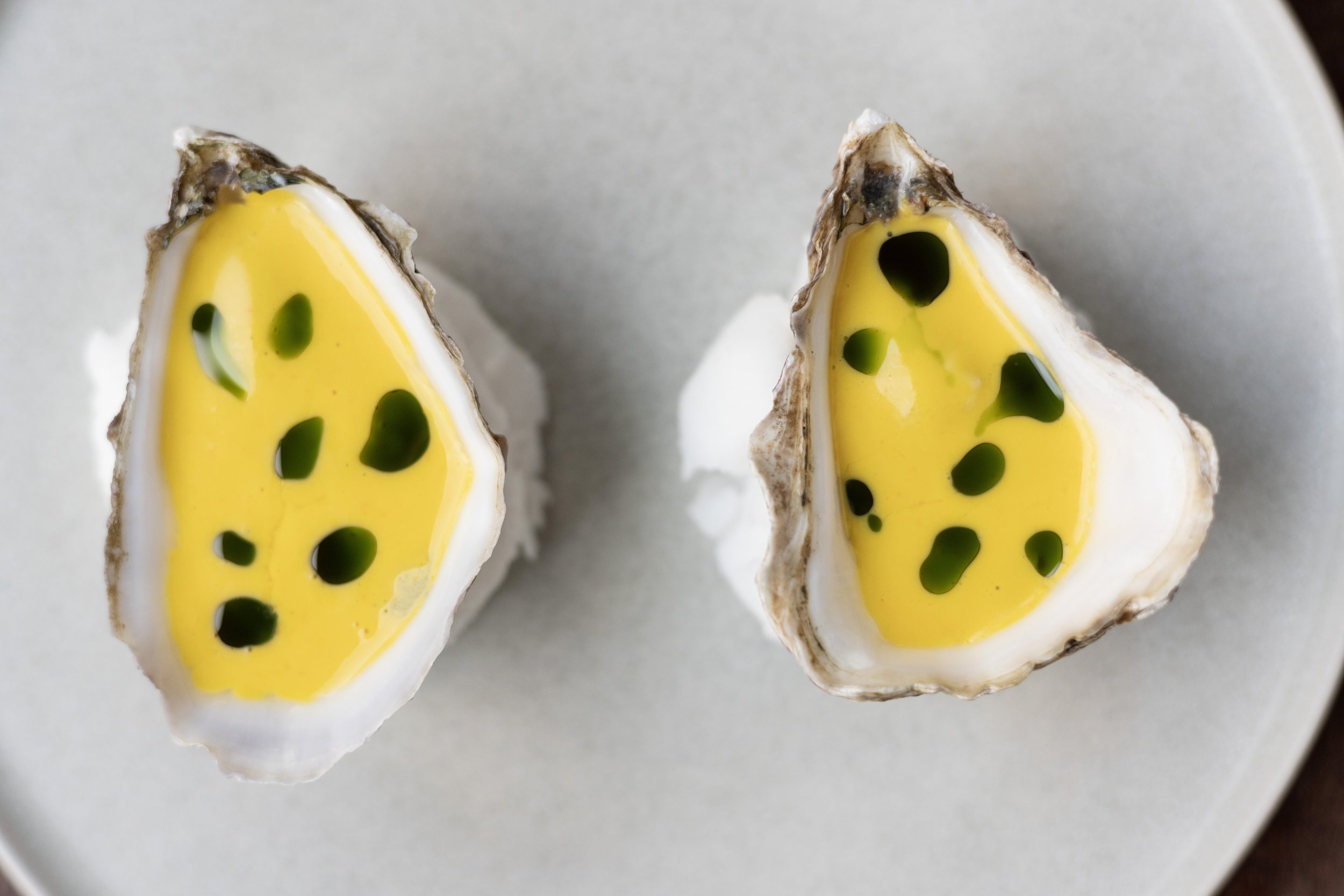 Close-up of two halves of a oysters, Peruvian style.